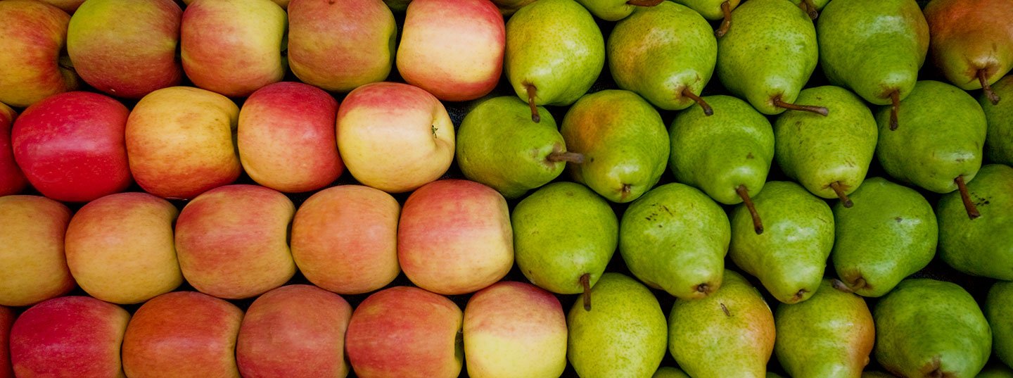 A neat arrangement of red apples and green pears