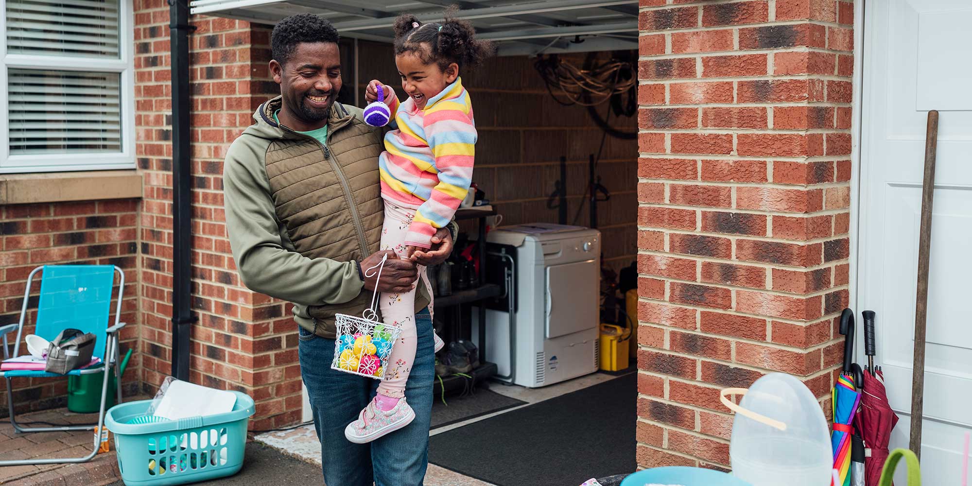 Father and daughter in front of garage