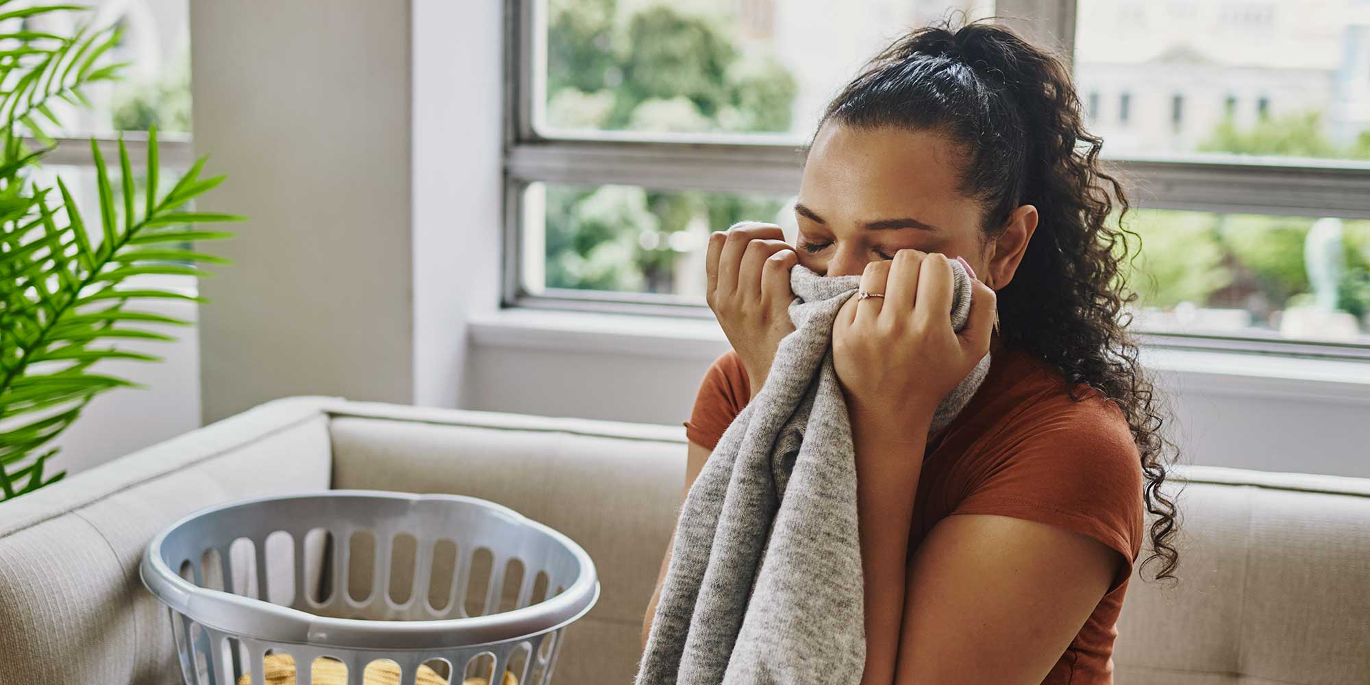 Woman smelling clean laundry